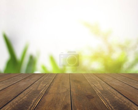 Abstract blurred green bokeh and brown wooden tabletop texture perspective counter for promoting and advertising product on display