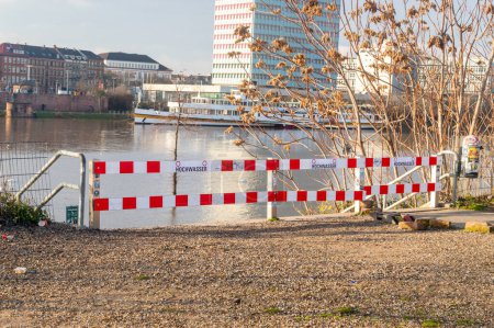 Photo for Mannheim, Germany - December 17, 2023: Barriers prohibiting entry to the embankment of the Neckar River due to high water levels. - Royalty Free Image