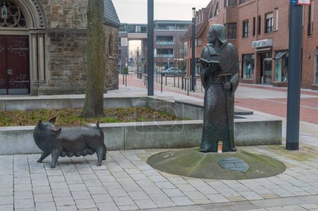Photo for Gronau, Germany - March 10, 2024: The St. Antonius with pig sculpture. - Royalty Free Image
