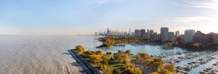 Photo for Aerial panorama overlooking Belmont harbor peninsula and the Lakeview neighborhood with the Chicago skyline in the distance. - Royalty Free Image