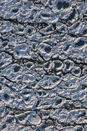 Photo for Top down aerial view of circular or rounded ice chunks encrusted in snow floating on the cold waters of Lake Michigan creating a fantastic abstract winter or textured background with copy space. - Royalty Free Image