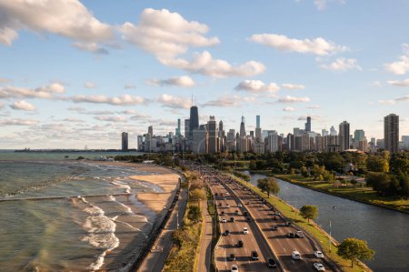 Foto de Downtown Chicago city skyline aerial centered over traffic along Lake Shore Drive between South Lagoon and Lake Michigan on a sunny day with fluffy white clouds in a blue sky above. - Imagen libre de derechos