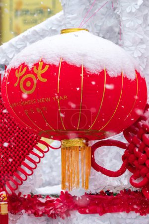 Photo for Chicago, IL - January 28th, 2023: Half snow covered decorative red and yellow Chinese lanterns hang off of a float during the annual Argyle Lunar New Year parade. - Royalty Free Image
