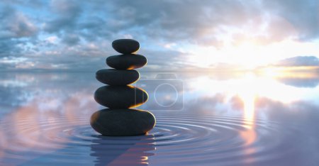 Photo for Japanese zen garden - stacks of pebbles in the wide ocean at sunset - Royalty Free Image