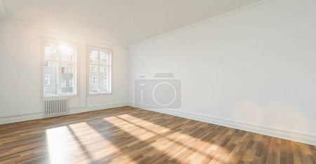 Photo for Empty room after renovation- two windows, white walls  and wooden floor in new apartment - Royalty Free Image