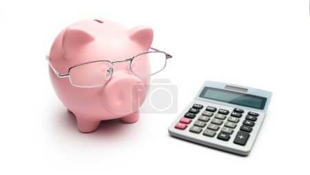 Piggy bank with calculator and Reading glasses on white background