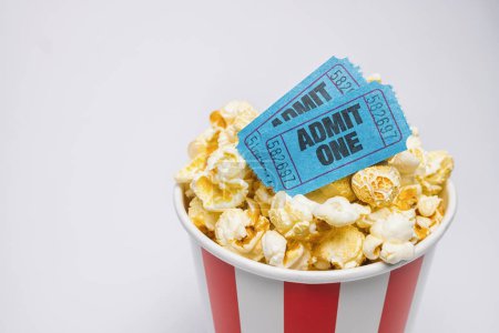 Photo for Popcorn in a box with cinema tickets on gray background - Royalty Free Image