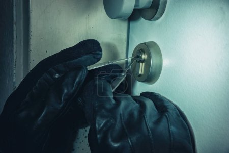 Photo for Criminal Picking Lock with Black Leather Gloves at Night - Royalty Free Image