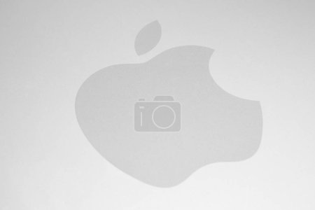 Photo for AACHEN, GERMANY FEBRUARY, 2017: White Apple logo on brushed aluminium background. Apple is the world's largest publicly traded company designs and sells consumer electronics and computer products. - Royalty Free Image