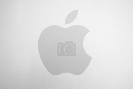Photo for AACHEN, GERMANY FEBRUARY, 2017: White Apple logo on brushed aluminium background. Apple is the world's largest publicly traded company designs and sells consumer electronics and computer products. - Royalty Free Image
