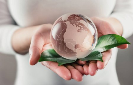 Photo for Protect the World - glass globe in hands - Royalty Free Image