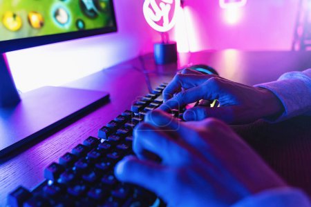 Professional cyber video gamer studio room with personal computer armchair, keyboard for stream in neon color blur background. Poster 645335130
