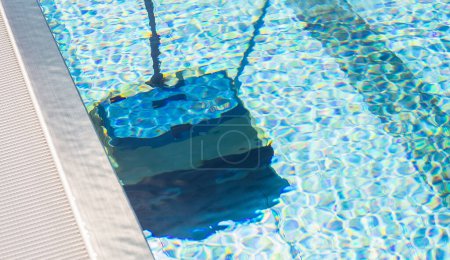 Reflection of a cleaning robot in a pool, with a distorted underwater view