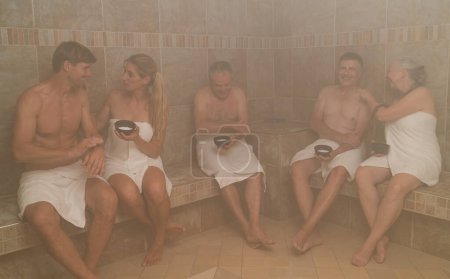 People in a steam bath with salt, engaging in conversation and relaxation at a spa wellness hotel