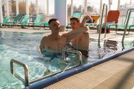 Rehabilitation session in a pool with a therapist and patient at rehab center