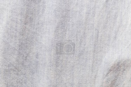 Téléchargez les photos : Gros plan sur le fond du tissu et la texture du jean chemise à manches longues de couleur bleue. - en image libre de droit