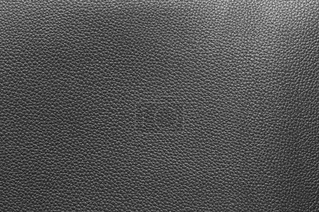 Foto de Black leather and a textured background. - Imagen libre de derechos