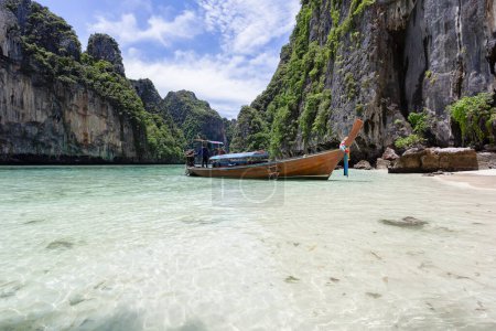 Photo for Traditional longtail boat with beautiful scenery view at Maya Bay on Phi Phi Leh Island in sunshine day. - Royalty Free Image