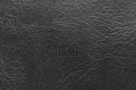 Foto de Black leather and a textured background. - Imagen libre de derechos