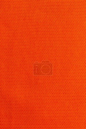 Foto de Color naranja ropa deportiva tela camiseta de fútbol jersey textura y fondo textil. - Imagen libre de derechos