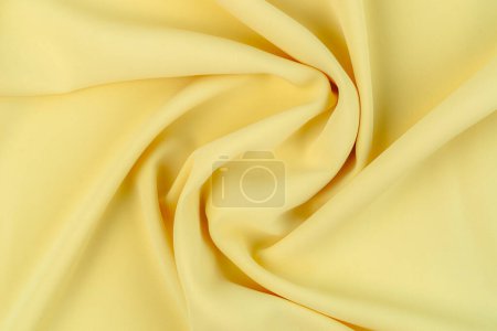 Foto de Tela de color amarillo tela poliéster textura y fondo textil. - Imagen libre de derechos