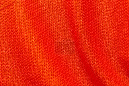 Téléchargez les photos : Couleur rouge vêtements de sport tissu maillot de football texture jersey et fond textile. - en image libre de droit