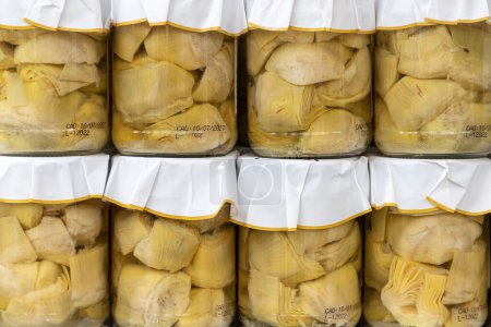 Photo for Close up in horizontal view of several glass jars with preserved artichoke hearts. food preservation concept - Royalty Free Image