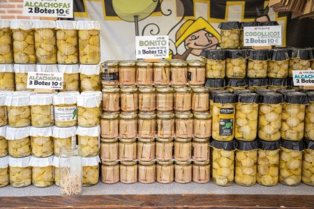 Photo for ALCALA DE HENARES, MADRID, SPAIN - OCTOBER 10, 2022: exhibitor with artichoke hearts and white tuna fillets preserved in glass jars from the Spanish brand Del Reino - Royalty Free Image