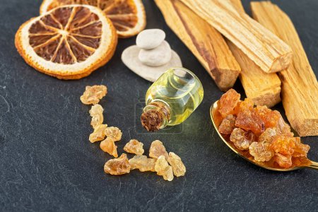 Photo for Smudge kit for spiritual practices with natural elements: Palo Santo sticks, dried orange fruit slices, SPA stones, essence and resin. - Royalty Free Image