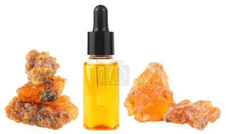 Bottle of essential oil with frankincense resin isolated on a white background. Olibanum aromatic resin. Incense and perfumes.