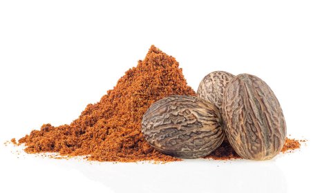 Dried seeds of fragrant nutmeg and grated nutmeg isolated on a white background