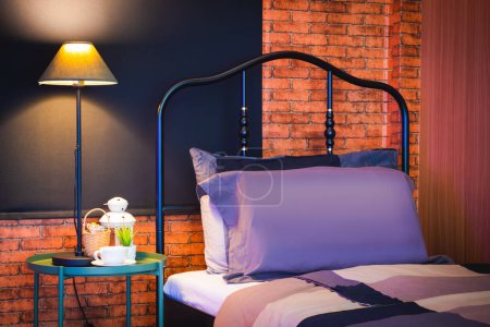 Photo for Modern classic style bedroom showing classical vintage design iron headboard matching brick wall and black blinds, feeling cool and timeless - Royalty Free Image