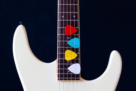 Photo for Colorful picks on white electric guitar. music background - Royalty Free Image