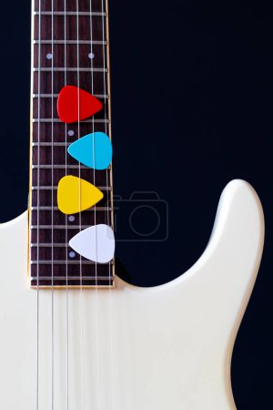 Photo for Colorful picks on white electric guitar. music background - Royalty Free Image