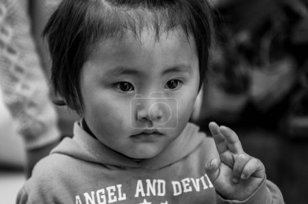 Photo for SHIGATSE, TIBET, CHINA - AUGUST, 21 2018: Unidentified little Tibetan child  in Shalu Monastery, Shigatse Prefecture, Tibet, China - Royalty Free Image