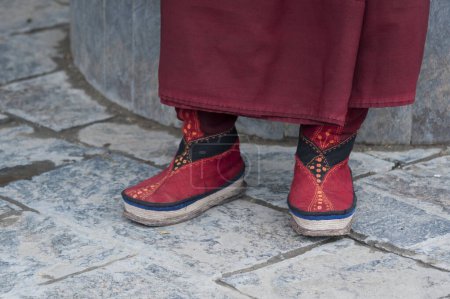 Photo for Typical Tibetan shoes of a Tibetan Pilgrim inside the Jokhang Temple in Lhasa, Tibet.It is one of the famous Buddhist monasteries in Lhasa - Royalty Free Image