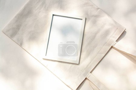 Photo for Cotton cloth and empty frame for text on a white background. Flat lay style - Royalty Free Image