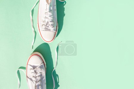 Photo for Two sneakers on a mint background. Flat lay style - Royalty Free Image