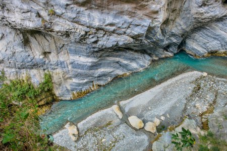 Photo for Scenic view of Swallow Grotto Yanzikou Trail with narrow turquoise Liwu River Gorge and high mountain cliff face in Taroko National Park, Xiulin Township, Hualien, Taiwan - Royalty Free Image