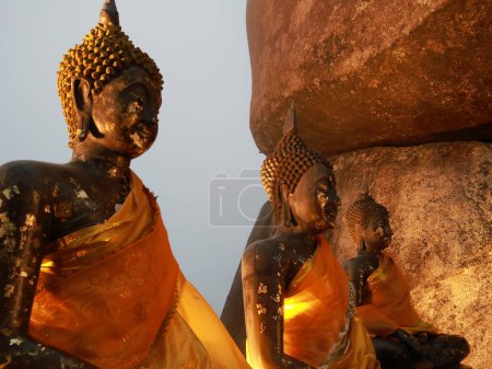 Photo for The three Buddha statues during sunset sitting on top of the mountain in Khao Khitchakut National Park located in Chanthaburi of Thailand - Royalty Free Image
