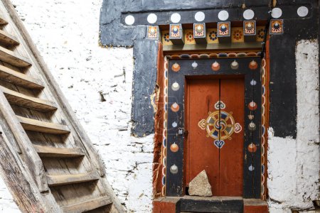 Entrance door and wooden stairs of Trongsa Dzong monastery in Trongsa, Bhutan, Asia