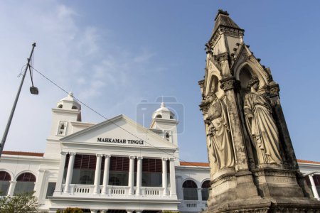 Neo gothic memorial statue and the Supreme Court Building (Malaysian: Mahkamah Tinggi)at Light Street (Lebuh Light) in the historic district of George Town, Penang, Malaysia, Asia