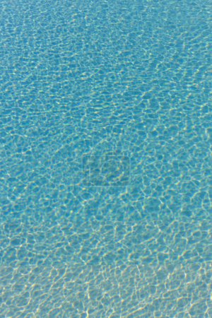 Different types of blue rippling water in a swimming pool with sunshine