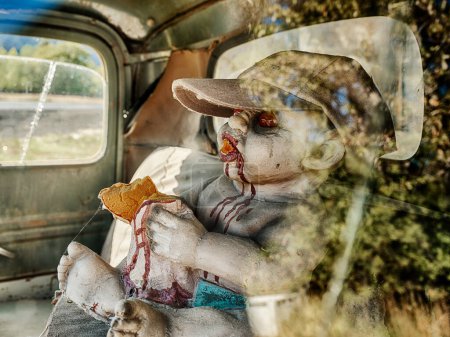 Photo for A scary doll covered in red blood sits in the driver's seat of an old truck near Naches, Washington. - Royalty Free Image
