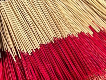 Photo for A bin filled with incense sticks creates a line of red. - Royalty Free Image