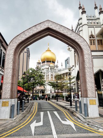 Photo for The golden dome of the Sultan Mosque in Singapore is framed by an Islamic arch. - Royalty Free Image