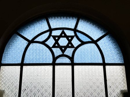 A stained glass window in a Singapore synagogue features a Star of David in blue and white glass as an architectural feature.