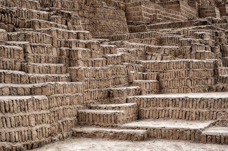 The ancient ruins of the Huaca Pucllana pyramid in Lima are constructed with rows of dried adobe bricks.
