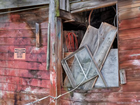 A window filled with debris is a reminder of the disrepair of an old boat yard on San Juan Island in Washington.