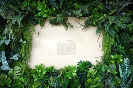 Photo for Beautiful tropical plant leaf decoration border on wooden planks background. - Royalty Free Image